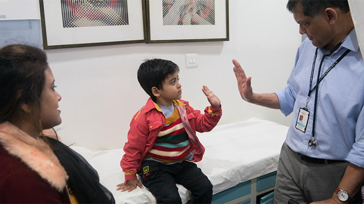 Professor Vaskar Saha with a patient in India.