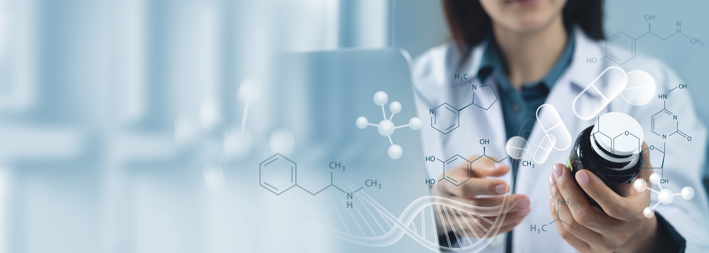 A scientist holding a bottle of medication.