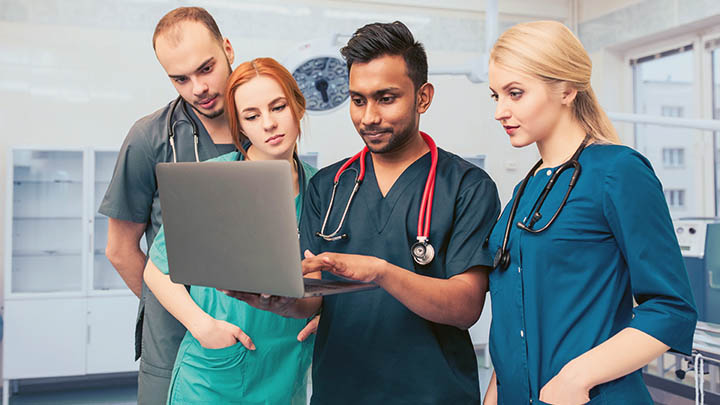 Medical students reviewing results with a surgeon.