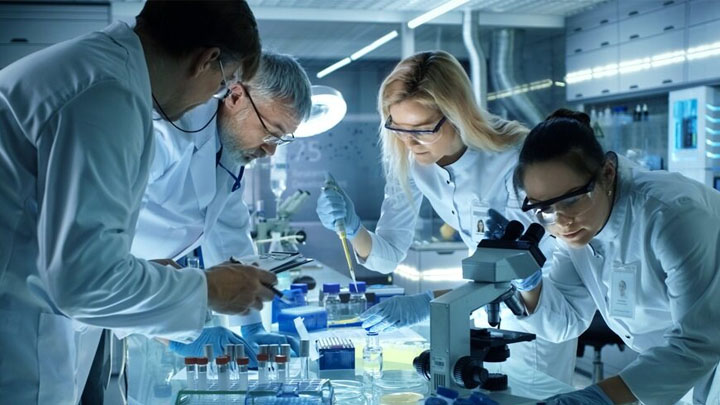 A team of pharmaceutical researchers working together in a lab.