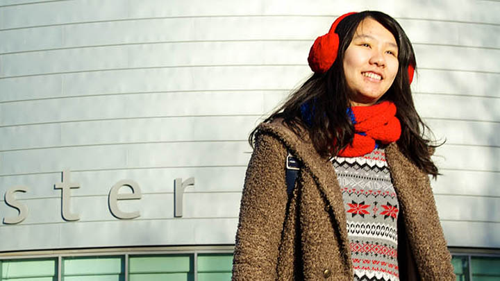 A student standing outside of University Place.