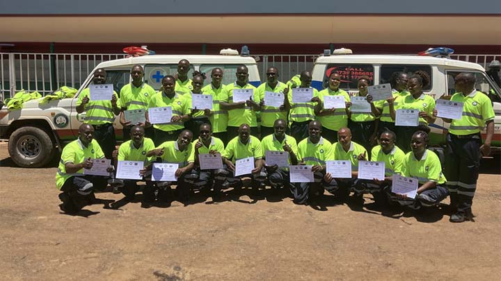 Graduates from the Kisii County Ambulance Service training programme holding their certificate.
