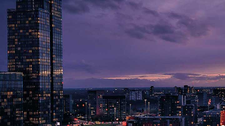 Manchester City Centre skyline at sunset.
