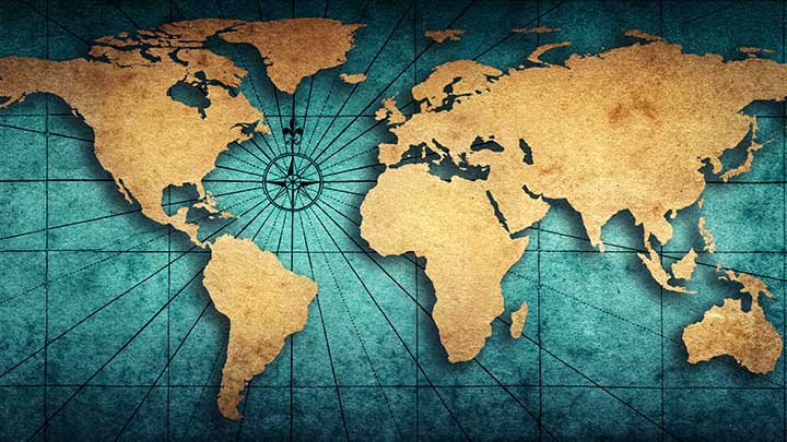 Map of the world on a old parchment background, showing compass points.