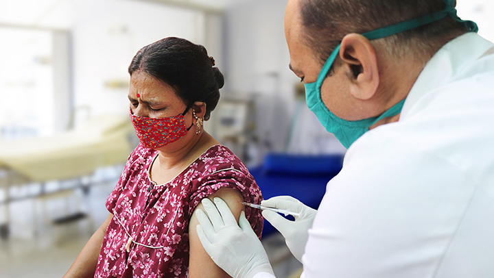 A woman receiving a vaccination in an Indian hospital.