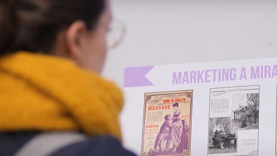 A person reading old medical and health adverts.