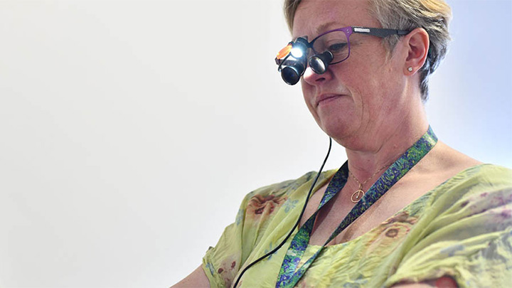 Dr Joanne Cunliffe, examining a dental patient's mouth.