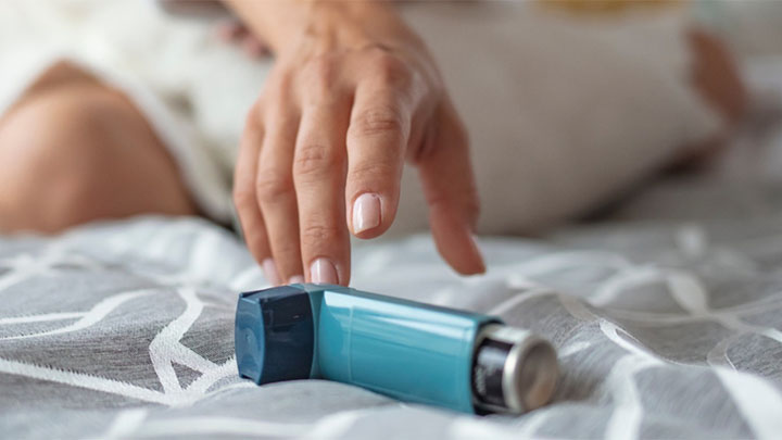 Hand reaching for an inhaler