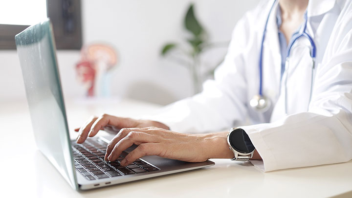 Close-up of hands typing on a keyboard.