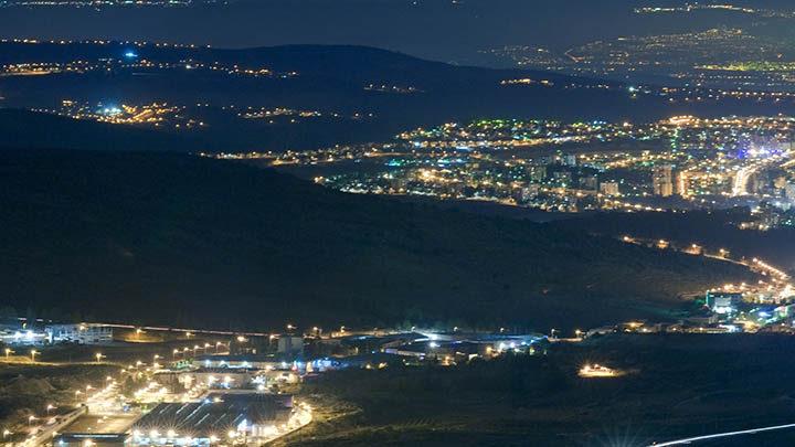 Nightime view showing lights from many towns.
