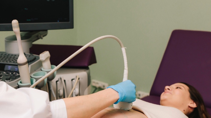 A pregnant woman undergoing an ultrasound.