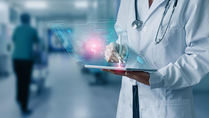 A doctor wearing a lab coat holding a digital tablet, with abstract futuristic graphics above.