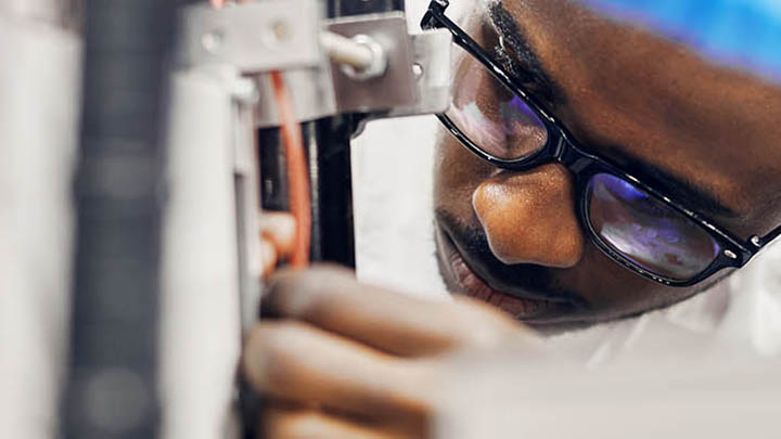 A researcher adjusts a piece of lab equipment.