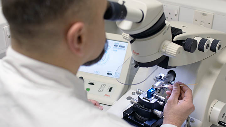 Researcher using an electron microscope.