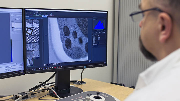 A researcher using a microscope.