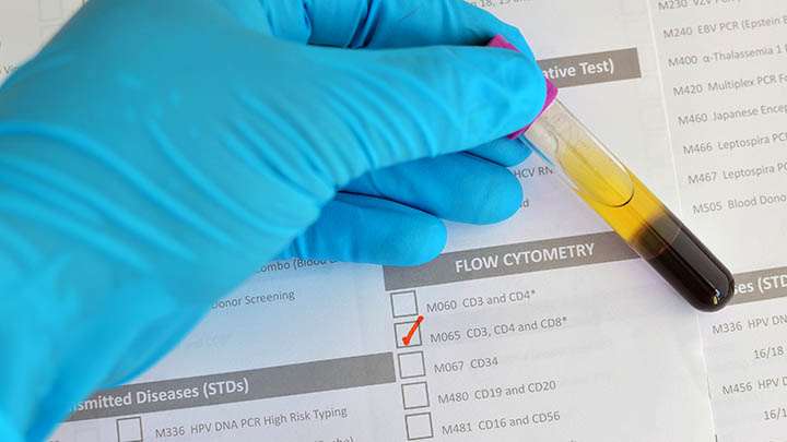 Researcher preparing a blood sample for a flow cytometer.