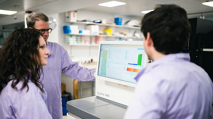 Research team analysing results on a computer in the lab.