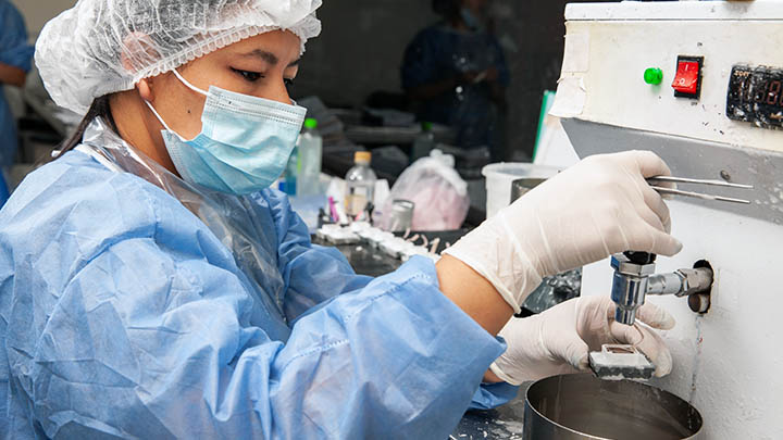 Scientist embedding tissues in paraffin blocks for sectioning.