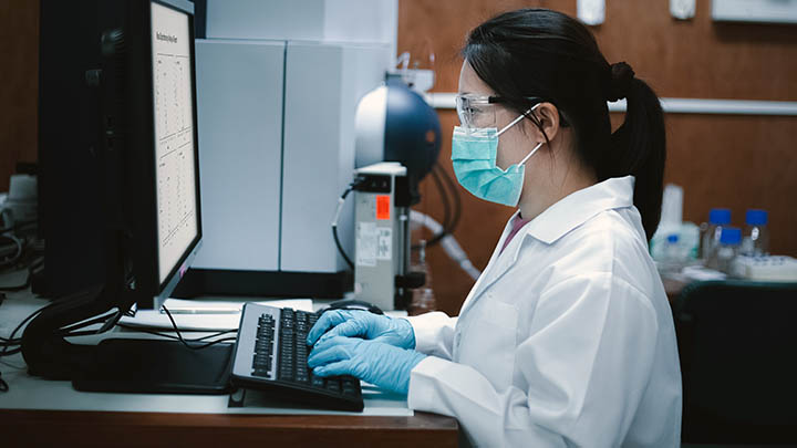 Researcher using a mass spectrometer.