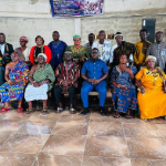 A group of African people in a hall.