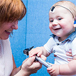 Audiologist with mother and child.