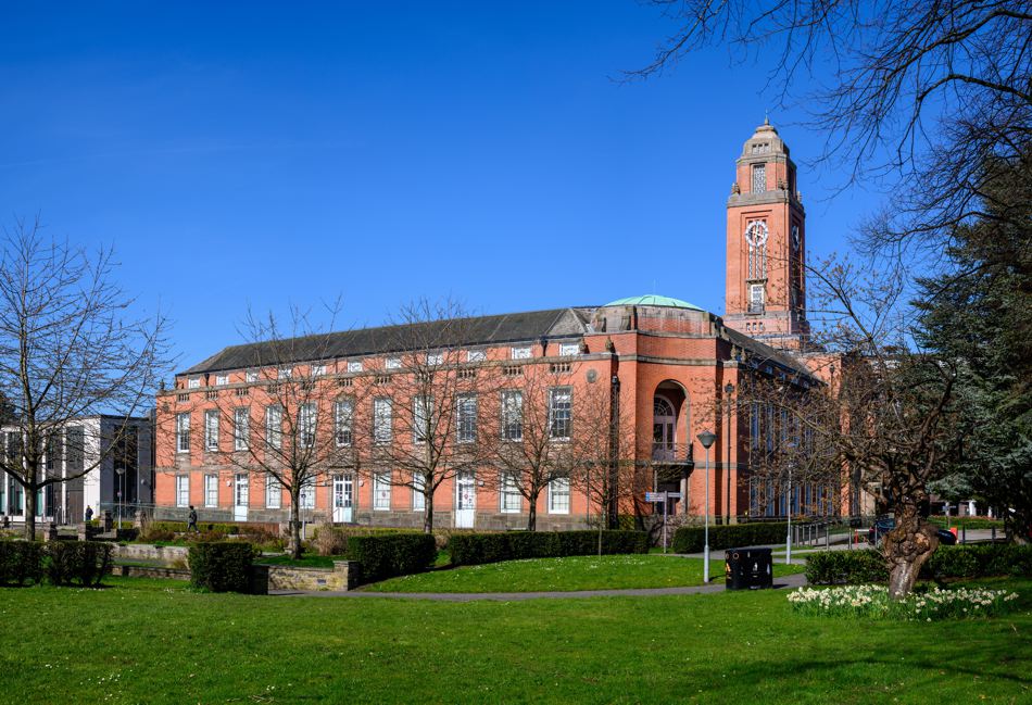 Trafford Council - a red-brick building against a blue sky.