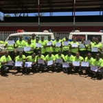 Graduates from the initial ambulance training programme holding their certificates.