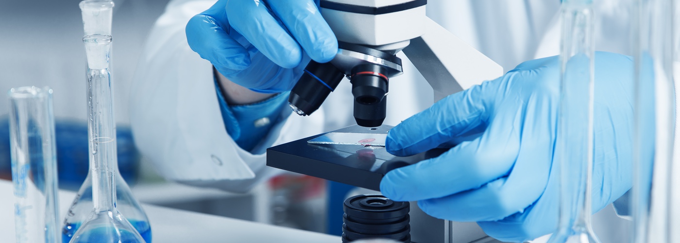 A scientist using a microscope.