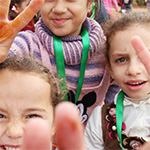 Children making peace signs.