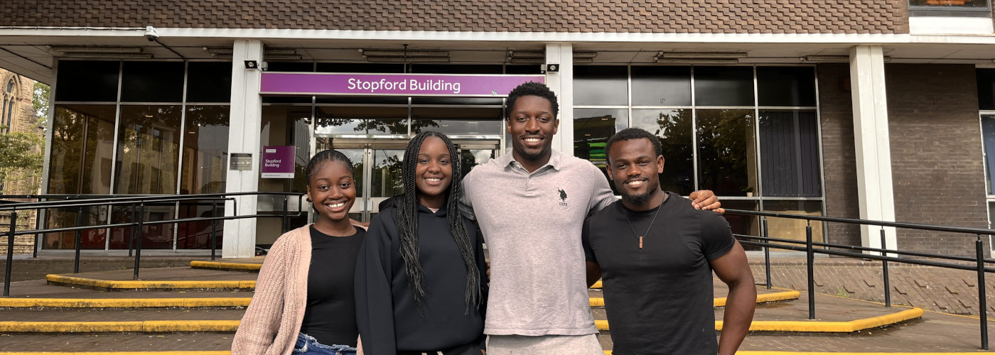 Four students on the steps of Stopford Building. From left to right: Elisha Goma Moukala, Farrah Adegunle, Carl Kulimushi, Meuke Cheta.