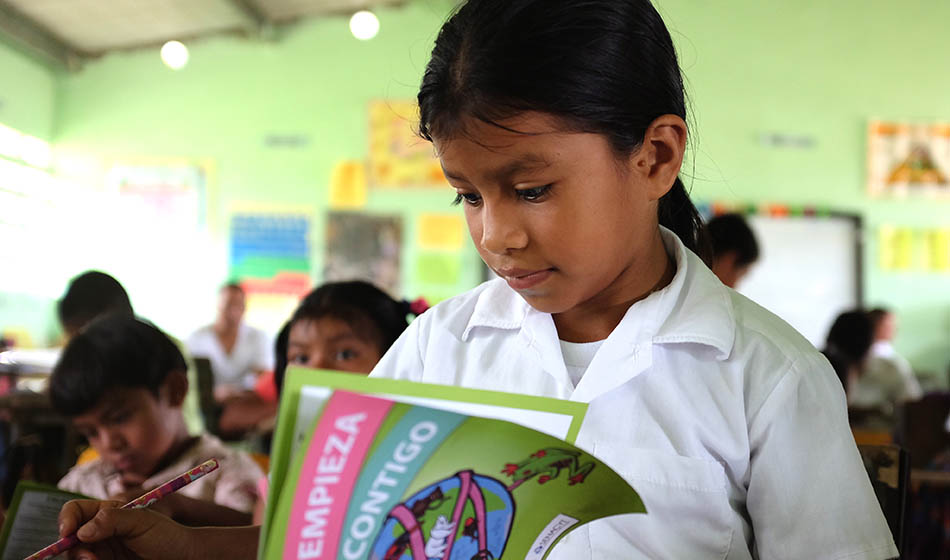 A child learning reading a book about conservation.