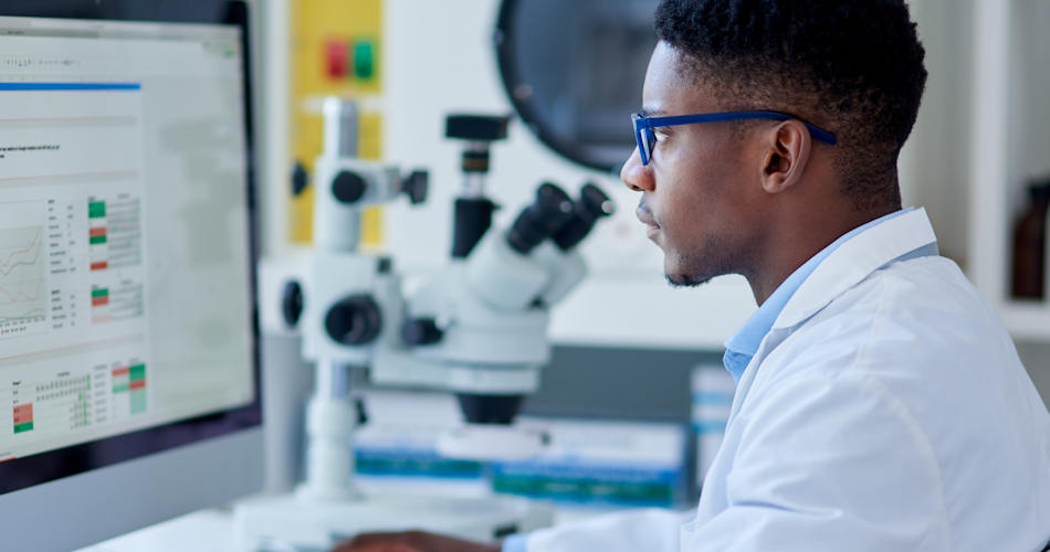 A scientist working with data on a computer.