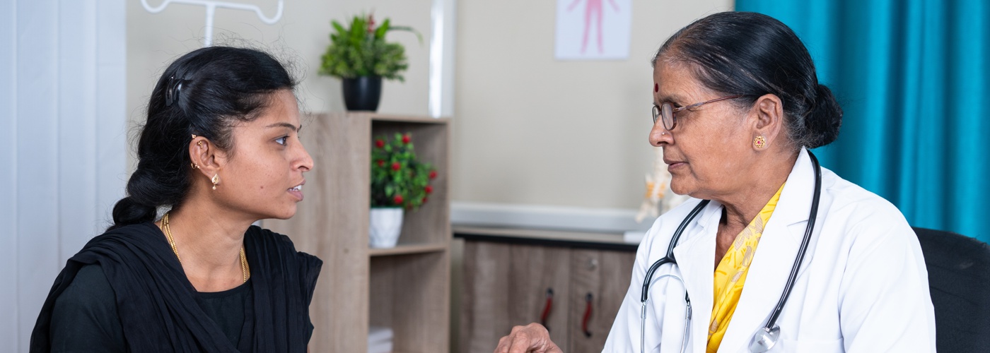An Indian doctor talking to a patient.