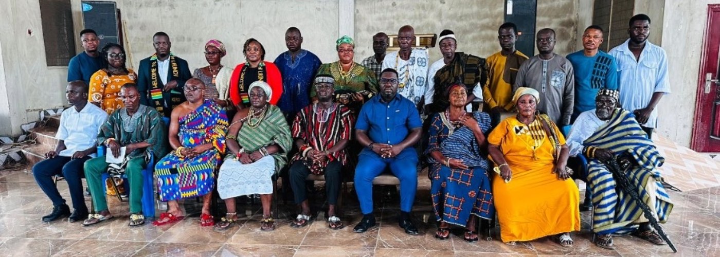 Adwoa with a group of people in a hall.