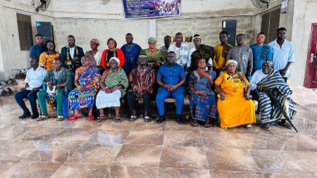 A group of African people in a hall.