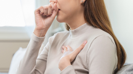 A woman coughing.