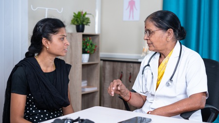 An Indian doctor talking to a patient.