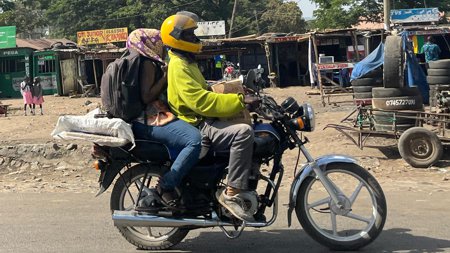 A man and a woman on a motorbike.