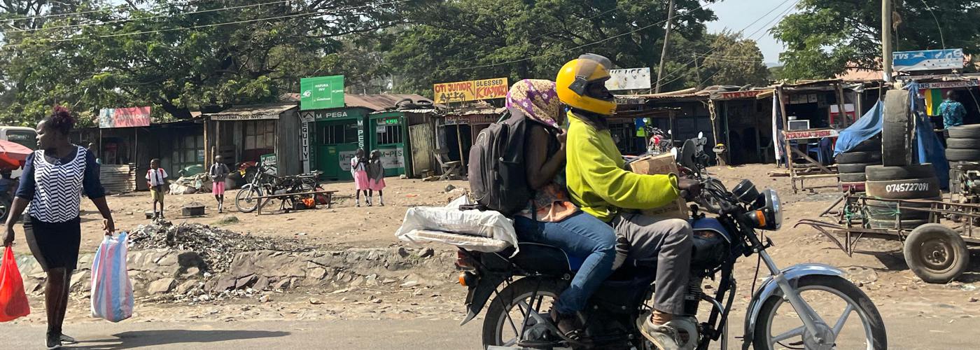 A man and a woman on a motorbike.
