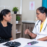 An Indian doctor talking to a patient.