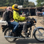 A man and a woman on a motorbike.