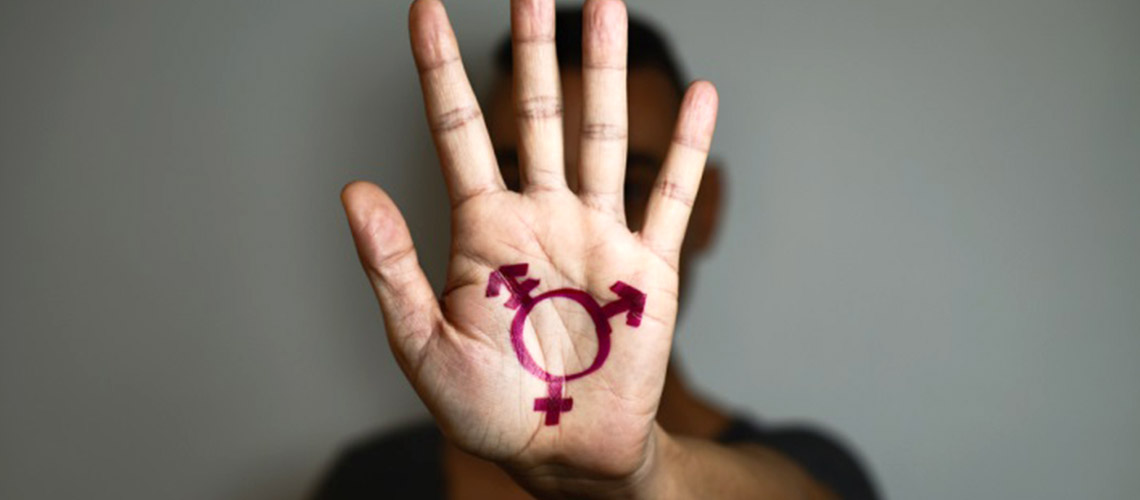 A hand with a transgender symbol drawn on it.