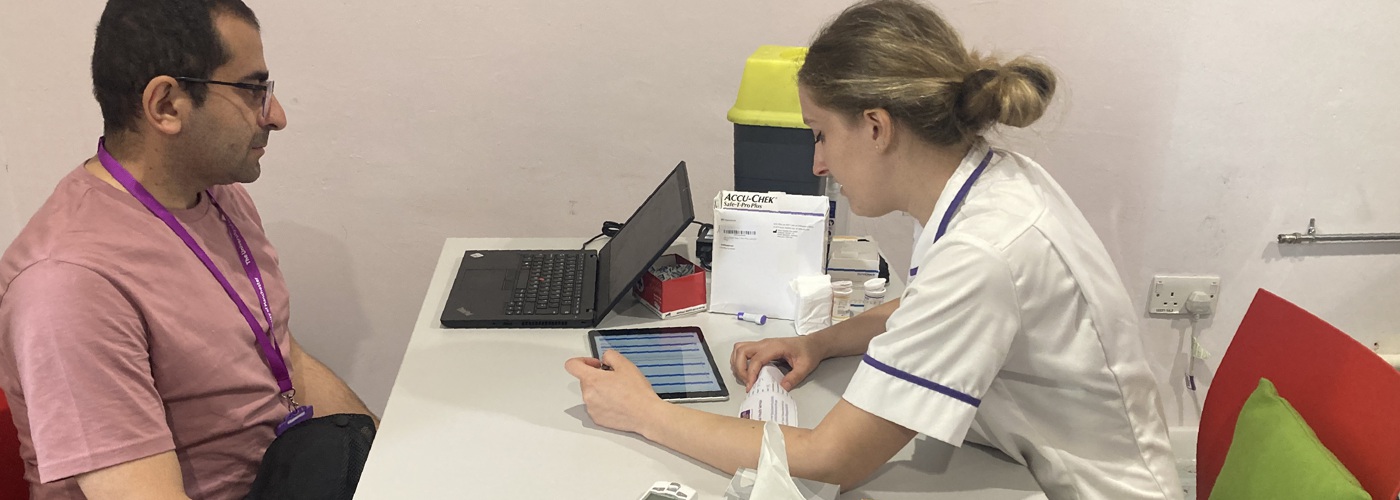 A Manchester student talking to a member of university staff.