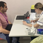 A Manchester student talking to a member of university staff.