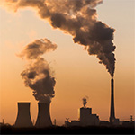 Silhouette of industrial factory smoke stack of coal power plant from chimney up on sky cause air pollution and destroy the Earth's atmosphere.