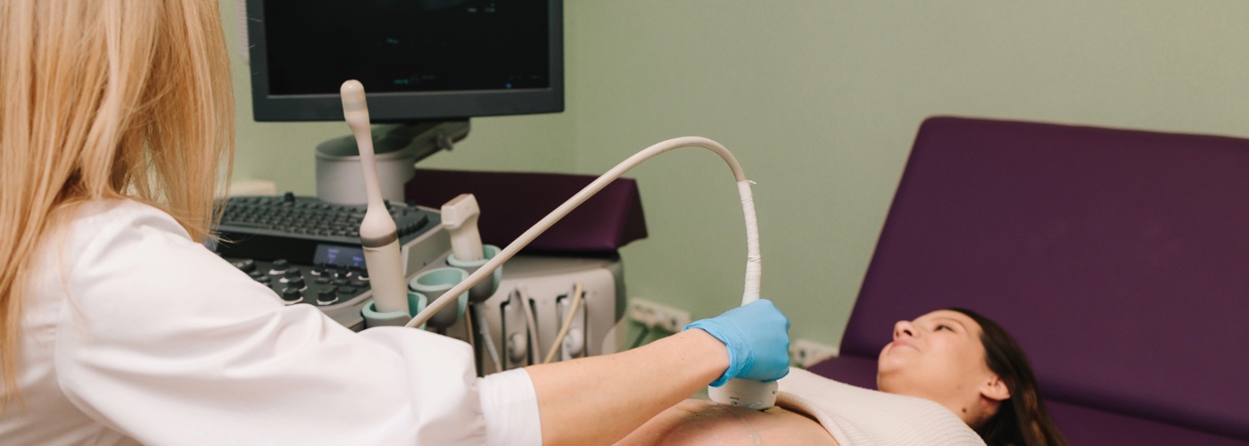 A pregnant woman undergoing an ultrasound.