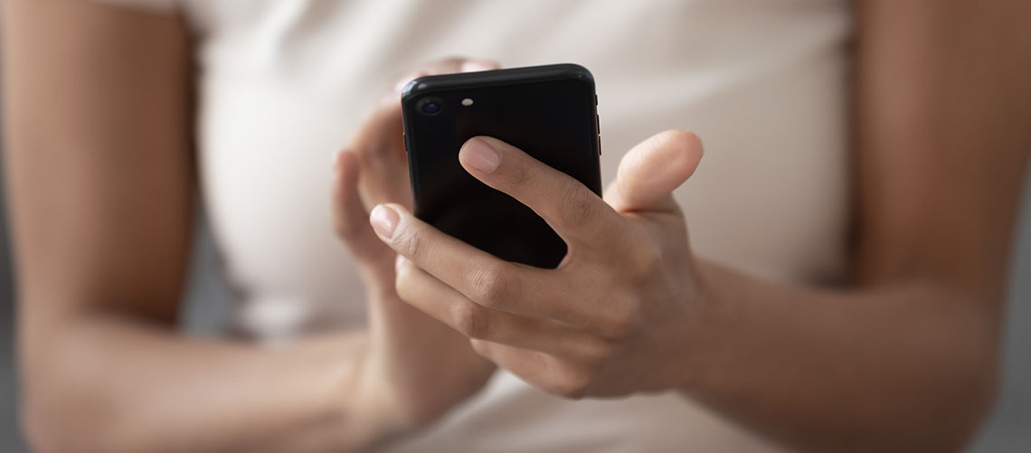 Close up of female using an app on mobile phone