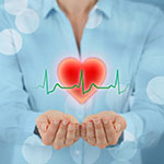 A woman holding a graphic of a heart in her hands.