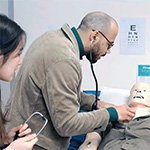 Manchester Pharmacy students learning clinical skills on a Sim man.