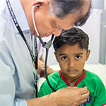 Professor Vaskar Saha treating a patient.